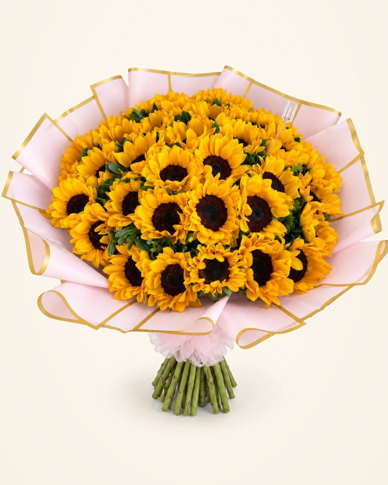 Bouquet gigante de girasoles en envoltura rosada y dorada