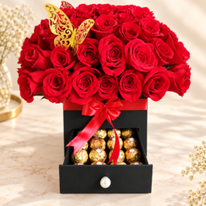 Caja negra con rosas rojas, mariposa dorada y cajón con chocolates