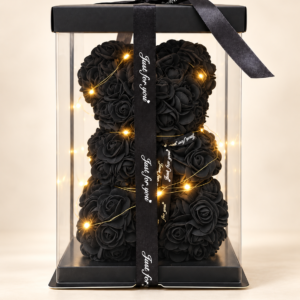 Oso teddy de rosas negras con luces cálidas en caja transparente