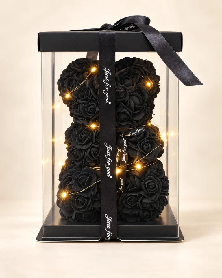 Oso teddy de rosas negras con luces cálidas en caja transparente