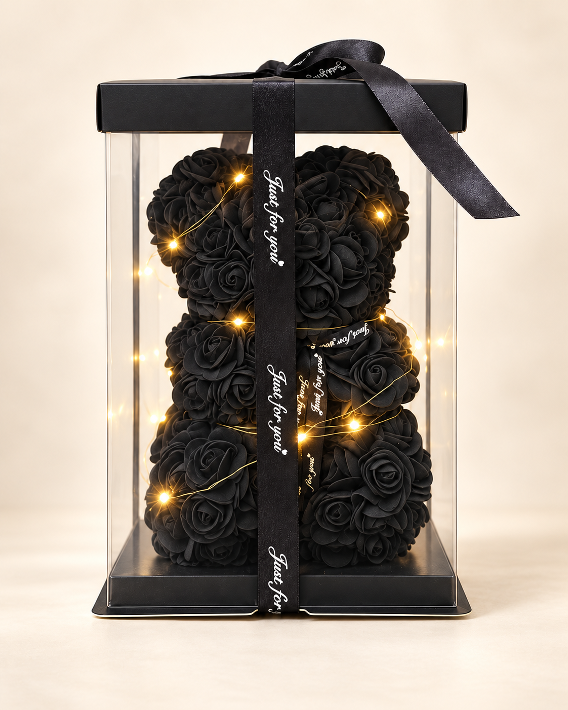 Oso teddy de rosas negras con luces cálidas en caja transparente